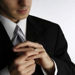 man staring at wedding ring