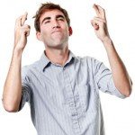 guy crossing his fingers for luck