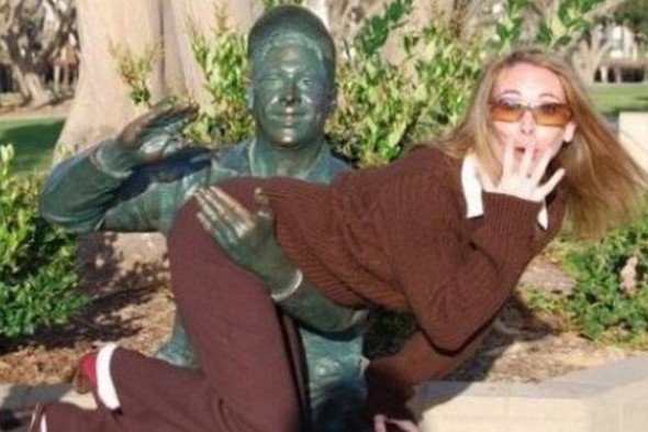 woman getting spanked by statue