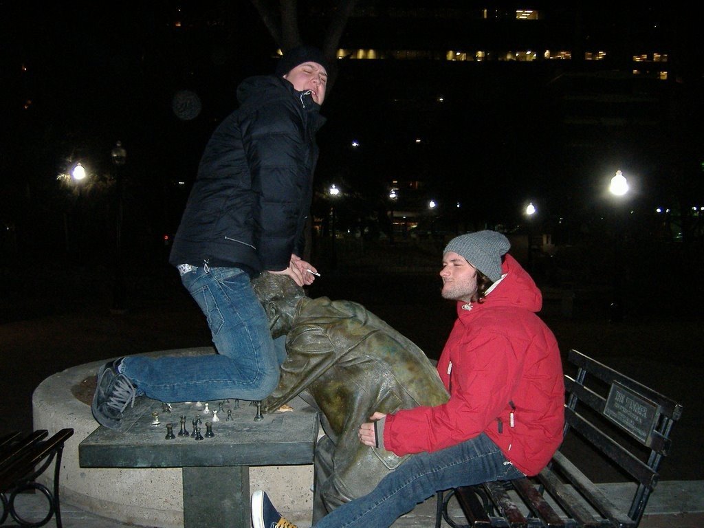 dudes tag teaming statue playing chess