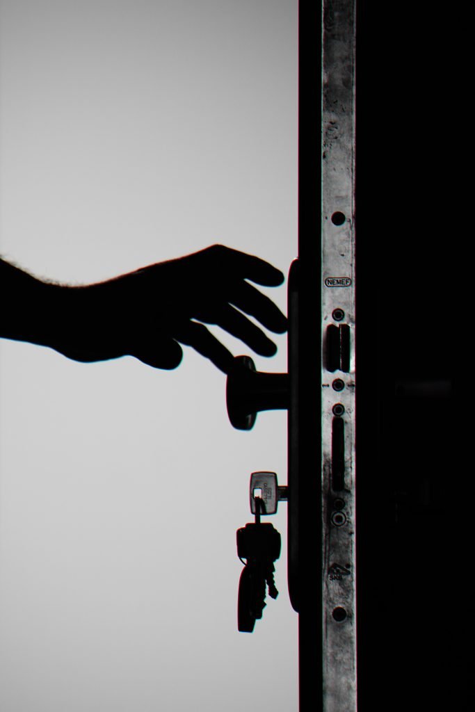 silhouette photo of person holding door knob 792032