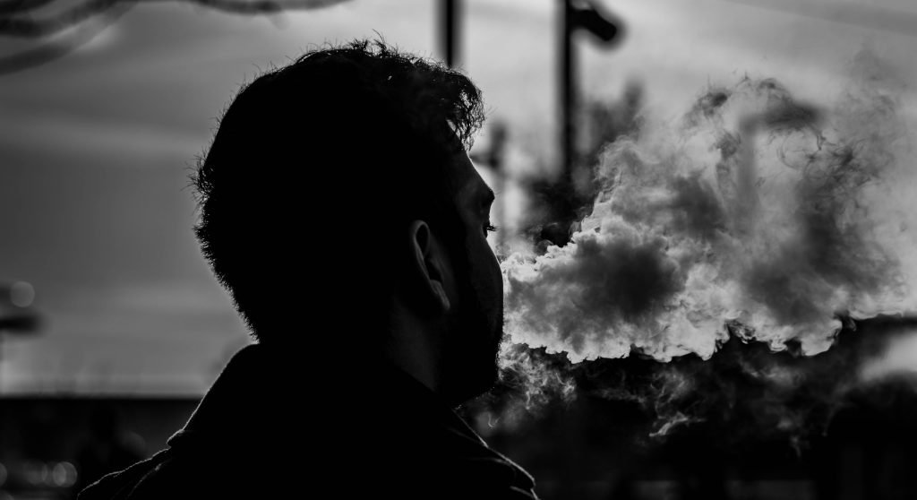 grayscale photography of man smoking 849203